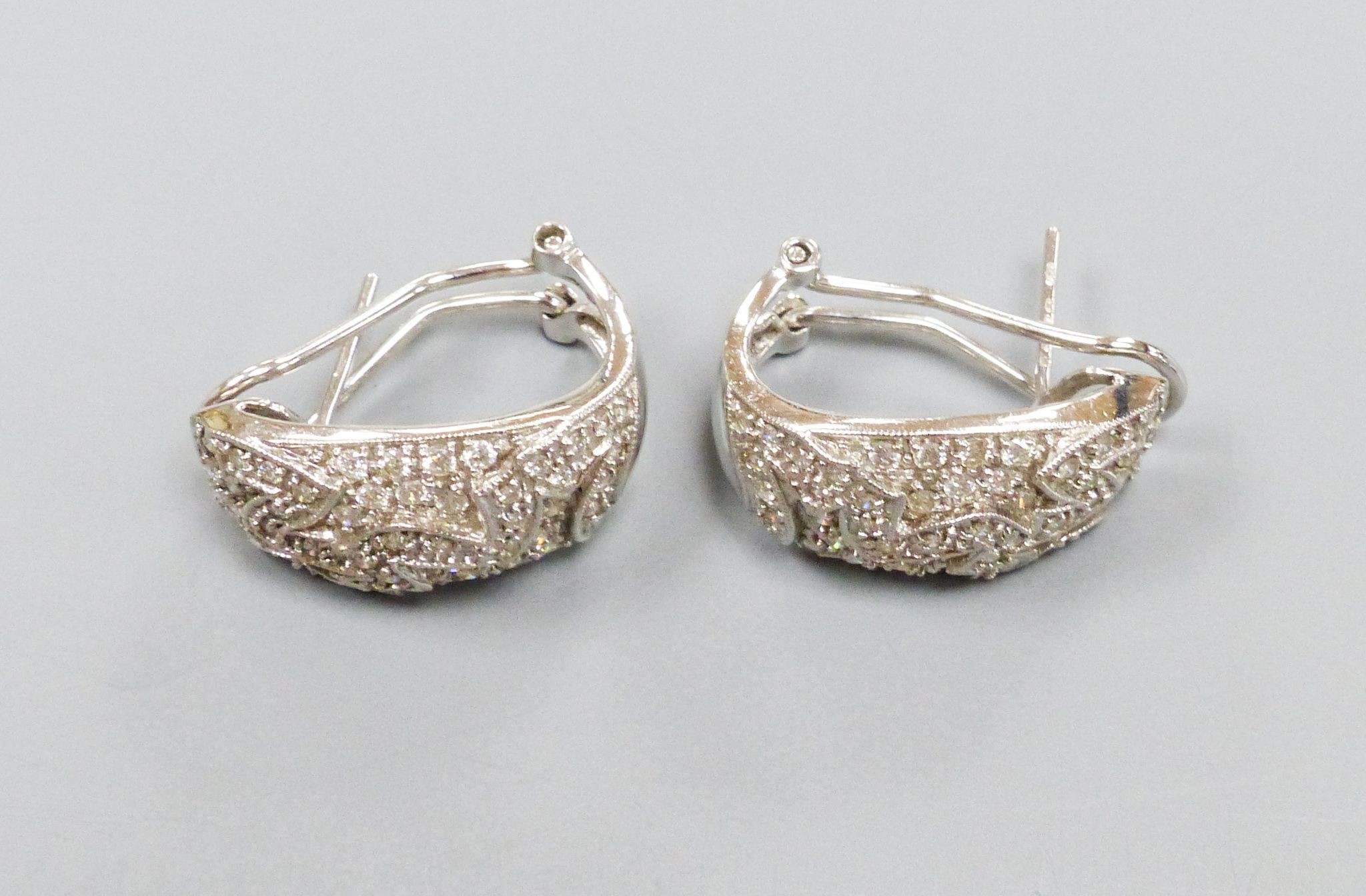 A modern pair of 18k white metal and pave set diamond demi-lune earrings, 21mm, gross 9.7 grams.